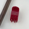 Detail view of the red acetate hair claw clip featuring golden Barrette La France text - Red