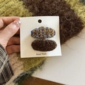 Detail of handmade oval hair clips in colorful tweed and dark brown faux shearling textures - Blue-Brown