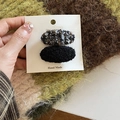 Detail of tweed and plush oval hair clips set on a handmade display card - Black