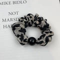 Detail of grey leopard print scrunchie with high elasticity and a glossy black bead - Black Gray Leopard (Style C)