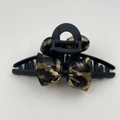 Detail view of stylish matte black hair claw with elegant leopard print fabric bows - Bow Claw Clip