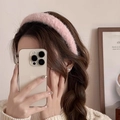 Close-up of a stylish pink plush headband worn by a woman for an elegant autumn look - Pink