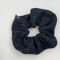 Elegant black polka dot scrunchie made of soft fabric with a minimalist brand label - Hair Tie / Black