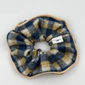 Detail of vintage blue and yellow checkered scrunchie with beige piping and woven brand label - Plaid Hair Scrunchie