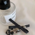 Detail of black fabric bow hair claw clip with heart pendant and gemstone embellishments - Black Bow Heart Hair Clip