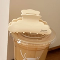 Close-up of cream acetate hair claw clip with La France text on a minimalist coffee cup - Beige