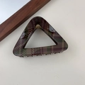 Detail of red and green plaid hair claw clip with golden spring on beige surface - Deep Plaid Triangle