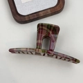 Close-up of a large red and green plaid hair claw clip with glossy finish - Bar Shape Light Plaid