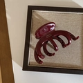 Detail view of handmade French burgundy acetate hair claw on a vintage display board - Burgundy