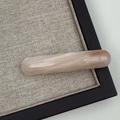 Close-up of elegant curved acetate hair clip with pink marble texture and Sanshine logo - Apricot