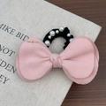 Close-up of pink layered wool bow hair tie with white pearls and gold metal detail - Pink