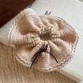 Detailed knit texture of a beige hair scrunchie with bow tie and gold charm detail - Khaki