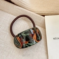 Elegant dark brown hair tie with a marbled resin geometric piece in earthy tones - Semi-Circle Hair Tie