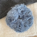 Close-up of a blue faux fur plush scrunchie showing detailed long fiber hair texture - Blue