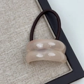 Detail of pink acrylic curved ornament on highly elastic coffee brown hair tie - Double Arc Apricot