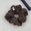 Close-up of fluffy brown plush hair scrunchie with a white Made Beautiful Girl woven label - Hair Tie / Coffee