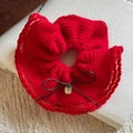 Detail of red knitted scrunchie with bow knot and engraved golden metal pendant - Red