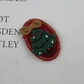 Handmade crochet Christmas tree hair clip with red oval base and gold silk edges - Red Base Christmas Tree