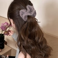 Elegant purple plush knitted hair scrunchie shown on a ponytail with soft lighting - Purple