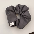 Detail of grey handmade scrunchie fabric texture and Hand Made textile label close-up - Hair Tie / Gray