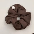 Detail shot of a dark brown scrunchie showing fine fabric texture and Hand Made label - Hair Tie / Brown
