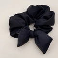 Close-up of black bubble textured fabric hair scrunchie with large puffy bow detail - Bow Scrunchie / Black
