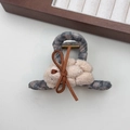 Close-up of a plaid bow hair clip featuring a white plush bear with brown faux leather bow - Gray Plaid Hair Claw