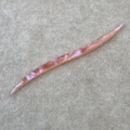 Detailed macro view of handmade pink acetate hair pin with pearlescent texture - Pink