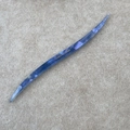 Macro shot of curved deep blue marble acetic acid hair pin with gold handmade lettering - Blue