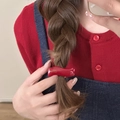 Detail of red wavy acetate hair clip with Handmade France gold lettering on model - Wave Style
