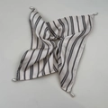 Detail view of striped silk scarf featuring elegant teardrop pearl corner pendants - White Striped Scarf