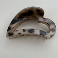 Detail view of heart-shaped hair claw clip with vintage tortoiseshell texture pattern - Light Leopard