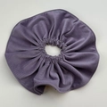 Close-up of a purple corduroy scrunchie with elastic folds on a grey background - Purple Oversized Scrunchie