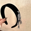 Detailed macro view of black velvet headband with ethnic silver tassel and bell charms - Single Side Silver Tassel Headband / Black