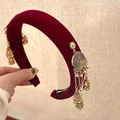 Close-up of wine red velvet headband with golden metallic tassels and small bell pendants - Double Side Tassel Headband / Red