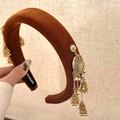 Close-up of handmade velvet headband with golden bell tassels and intricate metalwork - Double Side Tassel Headband / Caramel color