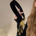 Detailed close-up of velvet headband with golden ethnic tassels and bells accessories - Double Sided Tassel Black Headband / Black