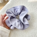 Close-up of lavender large scrunchie showing detailed fabric texture and pleated layers - Purple