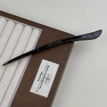 Close-up of elegant acetate hair pin with tortoise pattern and gold handmade logo - Blue Brown Gradient