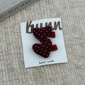 Pair of red heart-shaped fabric hair clips with white polka dots on a display card - Heart Style