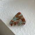 Close-up of handmade marble acetate hair claw clip with triangle design and France logo - Mint Green Brown Gradient