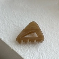 Macro detail of amber marble triangle hair claw clip with France Handmade text - Milk Coffee