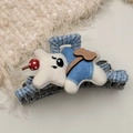 Detail of blue plaid hair claw featuring a plush cream bear with blue overalls and bow - White Bear Hair Claw
