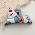 Close-up of cute plush white cat hair claw with blue plaid and cherry detail - White Dog Hair Claw