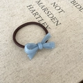 Detailed macro view of a blue acetate bow hair tie with gold France Handmade lettering - Hair Tie / Blue