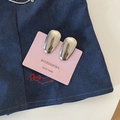 Detail of silver metallic bean hair clips on pink card over navy textured fabric - Solid Small Water Drop