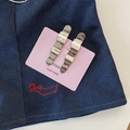 Detail of glossy silver wavy metal hair clips on a pink card with handmade text - Solid Wave