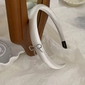 Elegant white satin headband featuring a delicate silver metal bow charm for women - Off-white