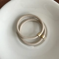 Two-piece set of beige elastic hair ties with elegant gold metal cylindrical accents - Beige