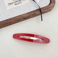 Close-up of a glossy red French acetate hair clip with a durable silver metal inner spring - Red